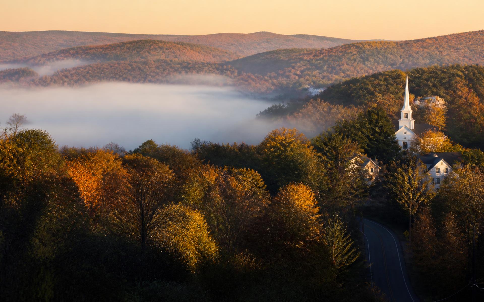 Misty autumn hills over a white church steeple in northeastern Connecticut
